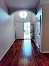 Foyer wood-type flooring . High Ceilings and indirect Lighting