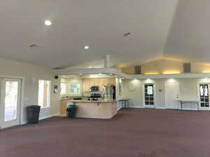 Full Kitchen, Doors open to Patio and Outside Pool