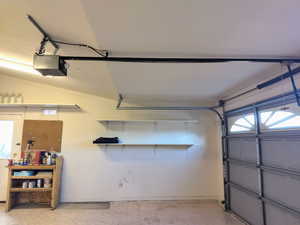 Garage with several Storage Shelves and Garage Door Opener