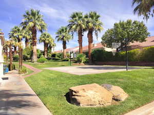 View of sport court with a lawn and community basketball court