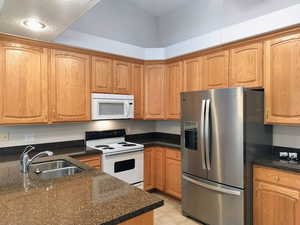 Kitchen featuring white appliances, Quartz Countertops,