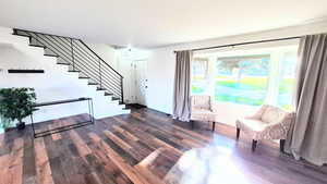 Entryway with dark wood-type flooring and stairway