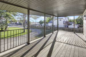 Wooden deck with a residential view and a lawn