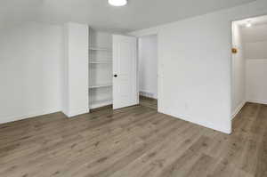 Unfurnished bedroom featuring light wood-type flooring and a closet