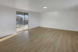 Empty room featuring baseboards and light wood-style floors