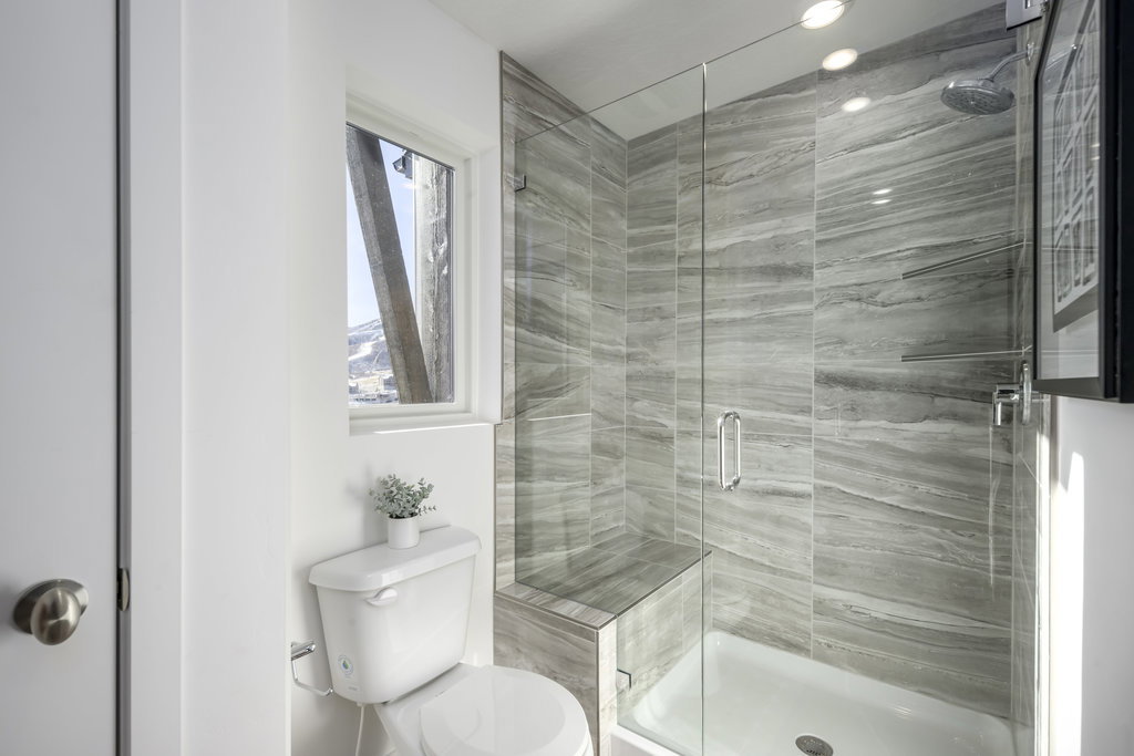 Dual sinks = relationship saver. Plus a walk-in shower that actually feels spa-worthy.