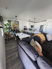 Living area featuring a textured ceiling and dark wood-style floors