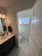 Bathroom with vanity and light tile patterned floors