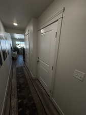 Hall with dark wood-type flooring and a textured ceiling