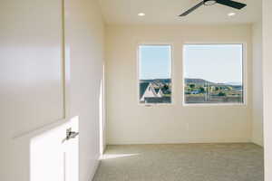 Spare room with light colored carpet, recessed lighting, and a ceiling fan