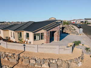 View of front facade featuring a residential view, brick siding, and stucco siding