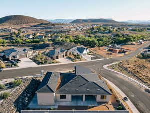 Aerial view of property's location with a mountain backdrop and nearby suburban area