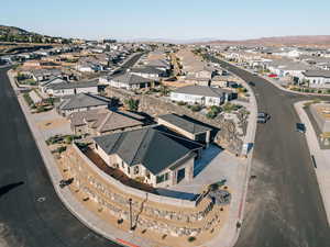 Aerial view of property's location with nearby suburban area and a mountainous background