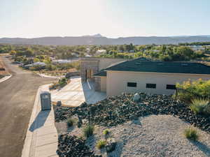 View of home's exterior with stucco siding, a mountain view, and stone siding