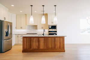 Kitchen featuring stainless steel appliances, backsplash, pendant lighting, and recessed lighting