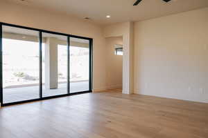Empty room featuring light wood-style flooring, recessed lighting, and ceiling fan