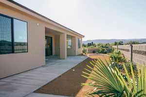 Fenced backyard featuring a mountain view and a patio area
