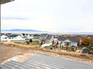 View of mountain backdrop featuring nearby suburban area
