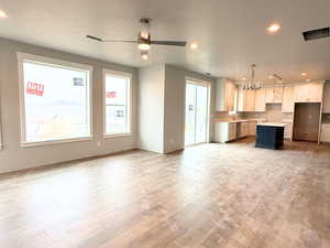 Kitchen featuring recessed lighting, open floor plan, plenty of natural light, decorative light fixtures, and light countertops