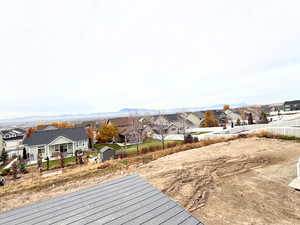 View of yard with a residential view and a deck with mountain view