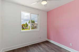 Spare room with dark wood-style flooring and ceiling fan