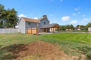 Back of property featuring a patio and a fenced backyard