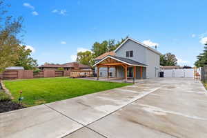 Back of house featuring a fenced backyard, a patio, and a gate