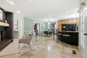 Living room featuring a fireplace, recessed lighting, and crown molding
