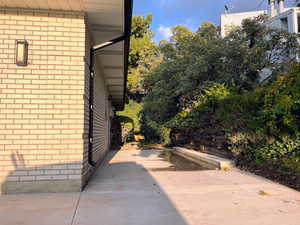View of side of home featuring brick siding