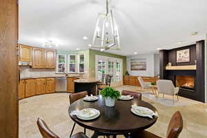 Dining room with a fireplace, a chandelier, and recessed lighting