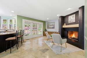 Dining area featuring a fireplace, french doors, and recessed lighting