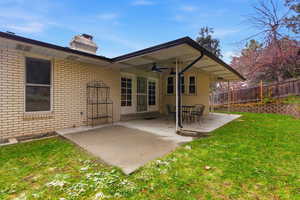 Back of house with a patio area, ceiling fan, brick siding, and a chimney