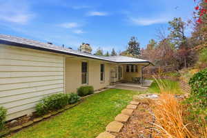 Rear view of property with brick siding, a patio, and a chimney