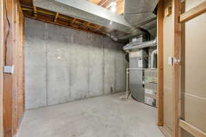 Unfinished below grade area featuring heating unit