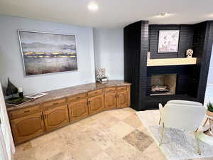 Sitting room with a fireplace and recessed lighting