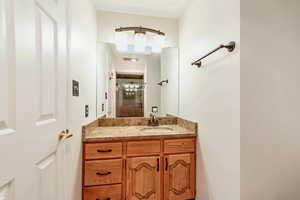 Full bathroom featuring vanity and a shower