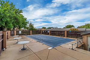 Community pool with a patio
