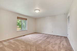 Unfurnished room with light colored carpet and baseboards