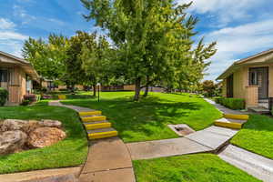 View of home's community with a yard