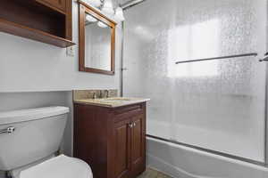 Bathroom featuring enclosed tub / shower combo and vanity