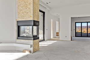 Detailed view of unfinished concrete flooring and a multi sided fireplace