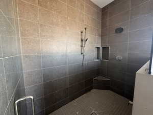 Full bath featuring a shower stall