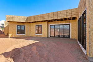 Rear view of property with stucco siding
