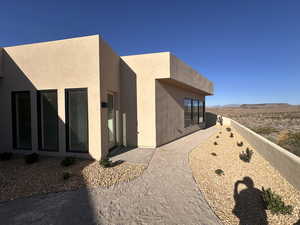 View of side of property featuring stucco siding and a mountain view