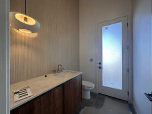 Bathroom with vanity and dark tile patterned flooring