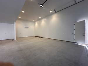 Misc room featuring a garage, concrete floors, and recessed lighting