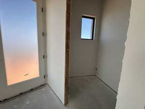 Corridor with unfinished concrete flooring