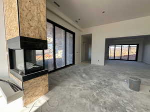Unfurnished living room with concrete floors