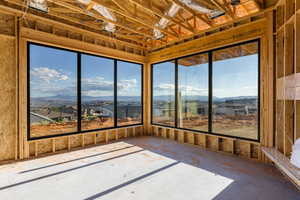 Unfurnished sunroom with a mountain view and a residential view