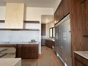 Kitchen featuring open shelves, decorative backsplash, dishwasher, wood finished floors, and refrigerator